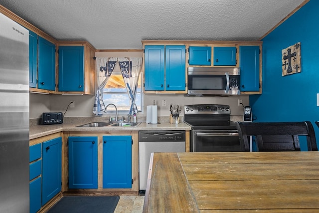 kitchen featuring a sink, stainless steel appliances, and blue cabinetry