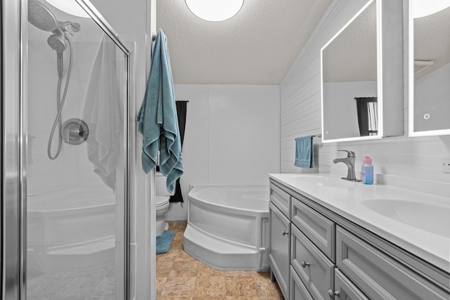 bathroom featuring a textured ceiling, a shower stall, double vanity, and a sink