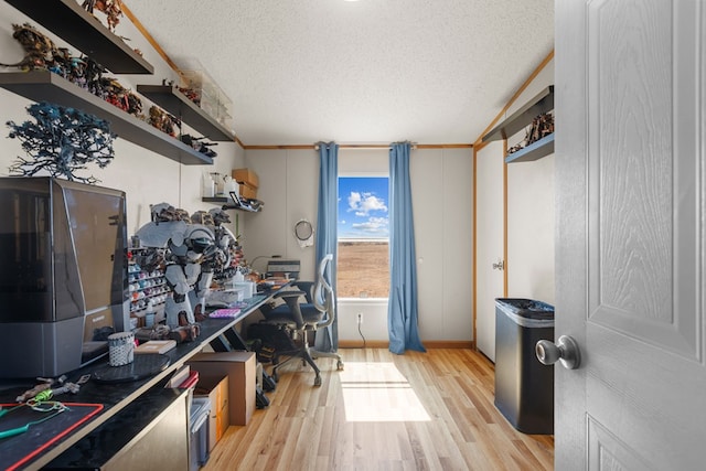 office space with light wood-style floors and a textured ceiling