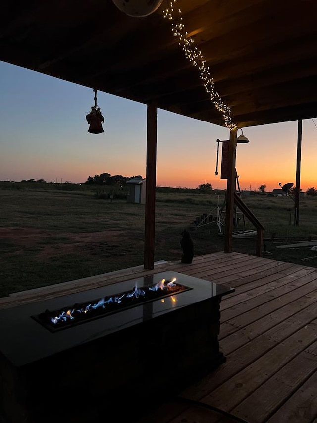 view of dock with a rural view and an outdoor fire pit