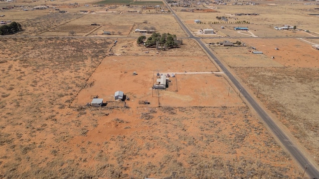 birds eye view of property featuring view of desert and a rural view