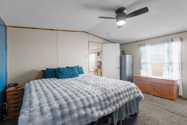 carpeted bedroom featuring a textured ceiling, vaulted ceiling, and ornamental molding