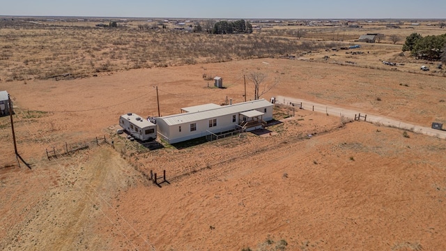 birds eye view of property featuring a rural view and a desert view