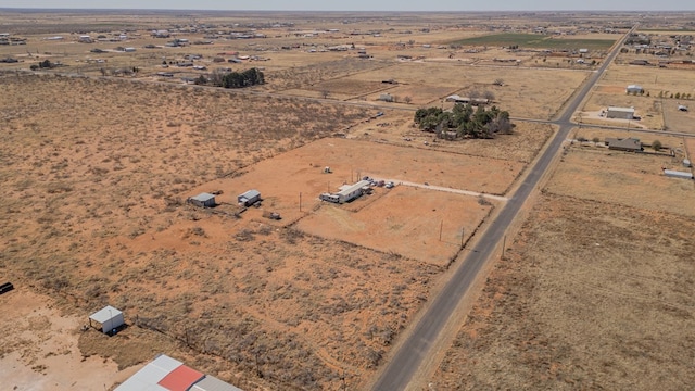 birds eye view of property with a desert view and a rural view