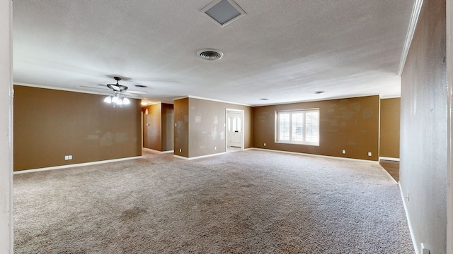 carpeted empty room featuring a textured ceiling, ceiling fan, and crown molding