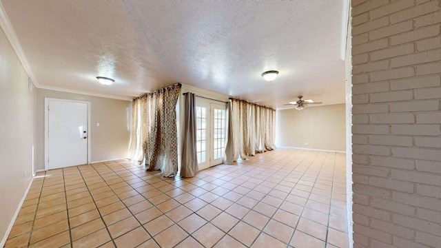 tiled spare room featuring ceiling fan, a textured ceiling, and ornamental molding