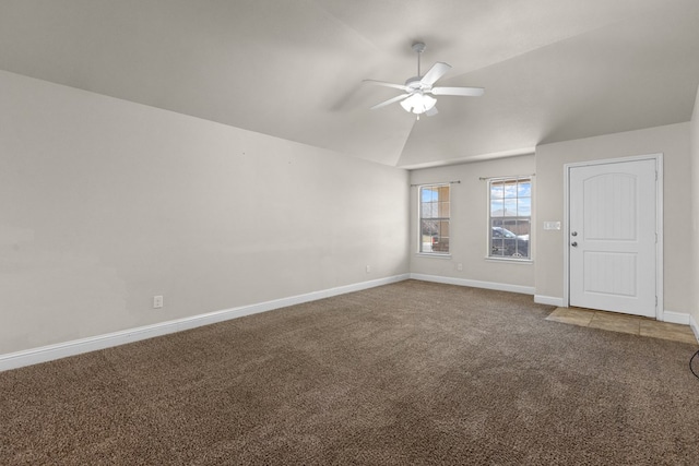 unfurnished room with lofted ceiling, a ceiling fan, baseboards, and carpet floors