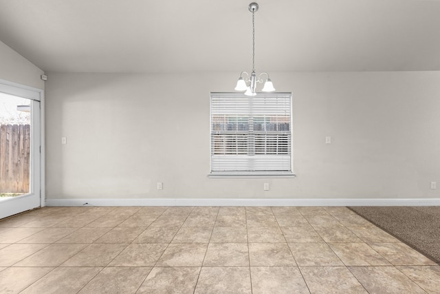 tiled empty room featuring baseboards, an inviting chandelier, and a healthy amount of sunlight