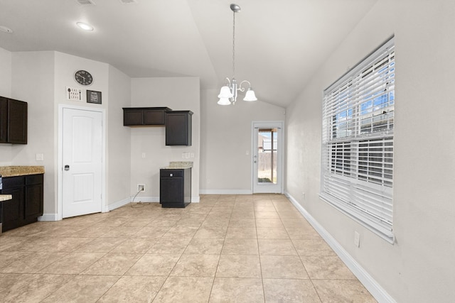 interior space with light tile patterned floors, baseboards, an inviting chandelier, lofted ceiling, and hanging light fixtures