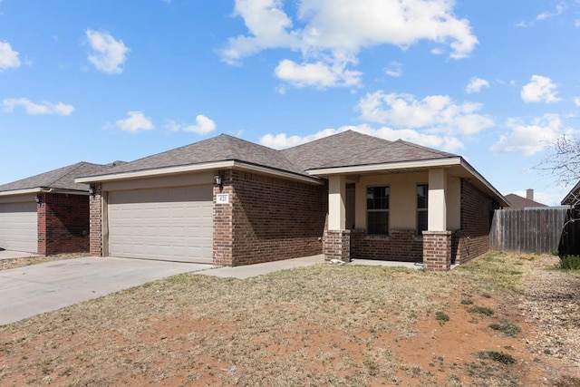 view of front of house featuring concrete driveway, a garage, fence, and brick siding