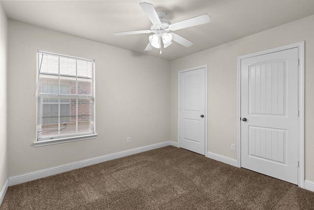 unfurnished bedroom with ceiling fan, baseboards, and carpet