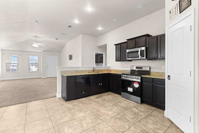 kitchen featuring visible vents, stainless steel appliances, a peninsula, light colored carpet, and ceiling fan