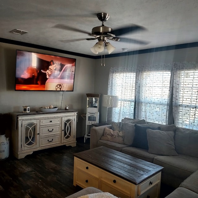 living room with dark wood-type flooring and ceiling fan