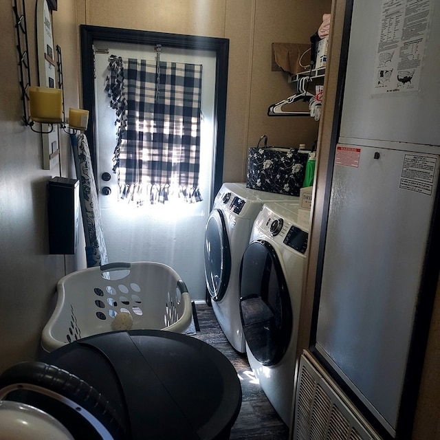 laundry area with heating unit and washer and dryer