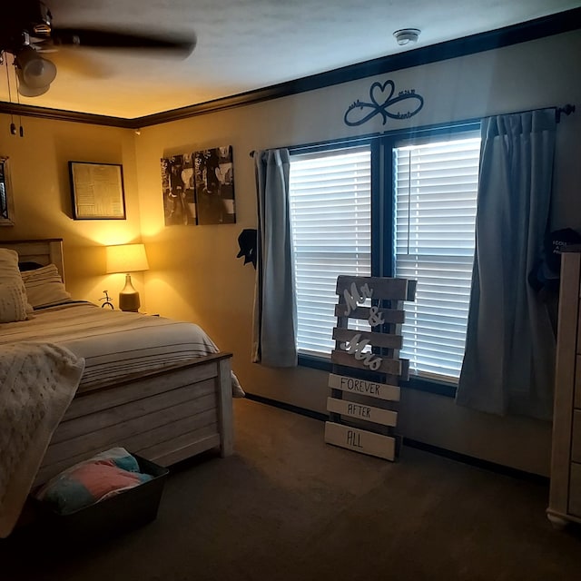 carpeted bedroom with multiple windows, ornamental molding, and ceiling fan