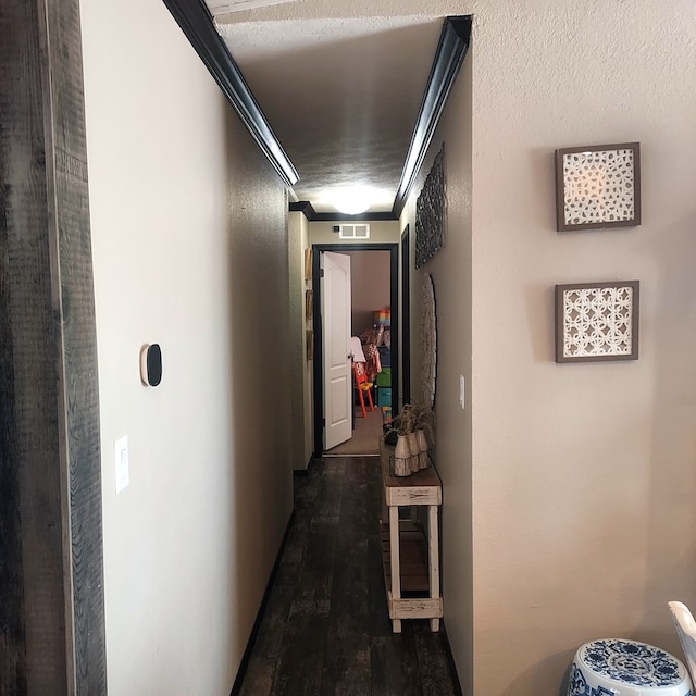 corridor with crown molding and dark hardwood / wood-style floors