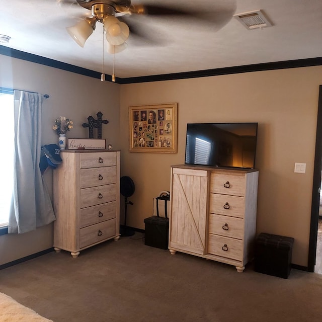 unfurnished bedroom featuring dark colored carpet, ornamental molding, and ceiling fan