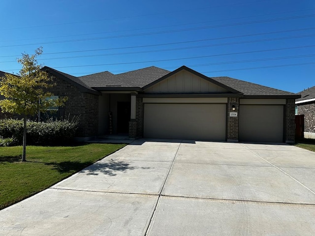 view of front of house featuring a front yard and a garage