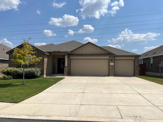 view of front of home with a garage and a front lawn