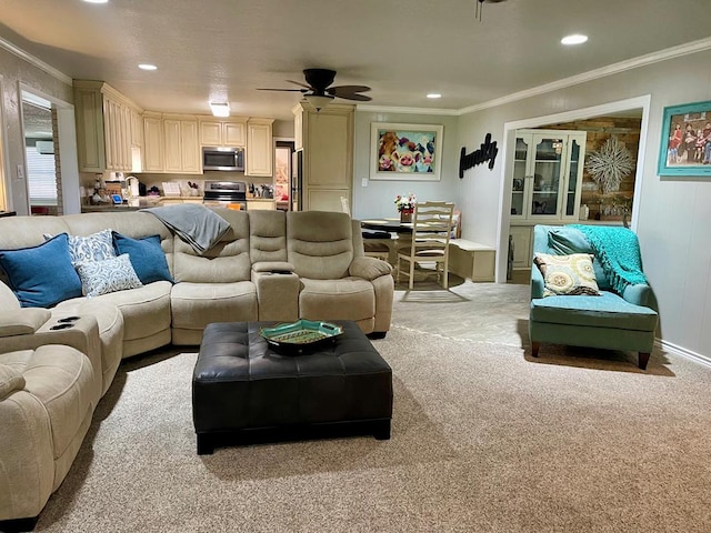 living room with ceiling fan, sink, ornamental molding, and light carpet