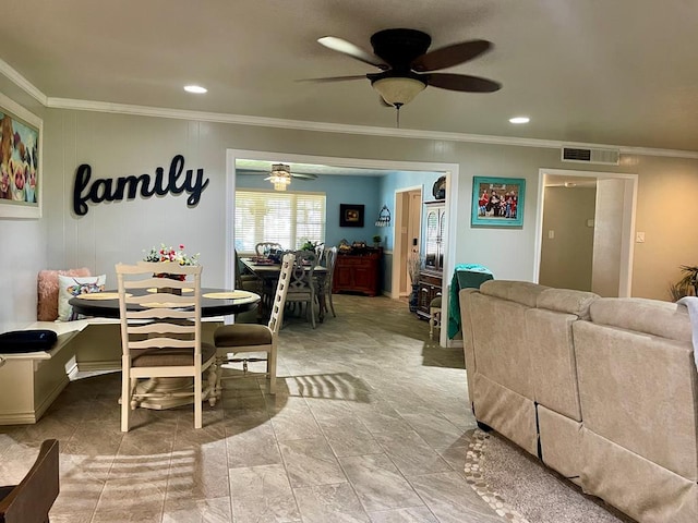 dining room with ceiling fan and crown molding