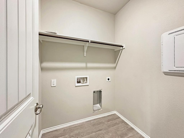 washroom with baseboards, washer hookup, laundry area, wood finished floors, and electric dryer hookup