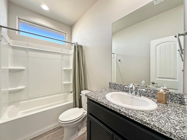 bathroom featuring vanity, wood finished floors, toilet, and shower / bathtub combination with curtain