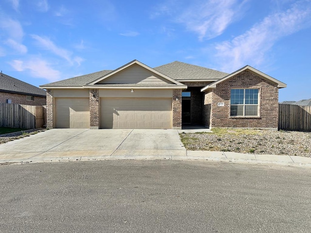 view of front of house featuring driveway, fence, roof with shingles, a garage, and brick siding