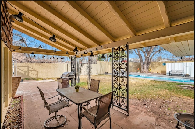 view of patio / terrace featuring a fenced in pool and a grill