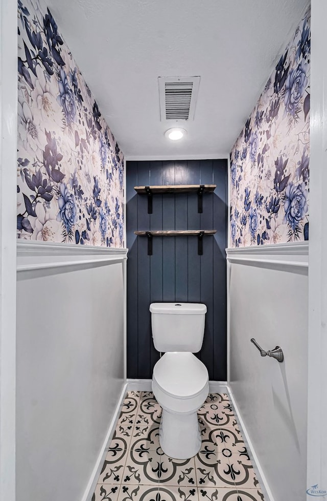 bathroom with toilet and tile patterned flooring