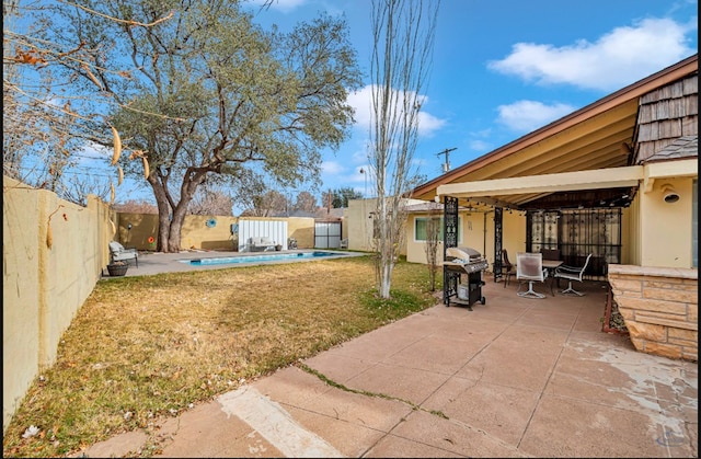 view of yard featuring a patio and a fenced in pool