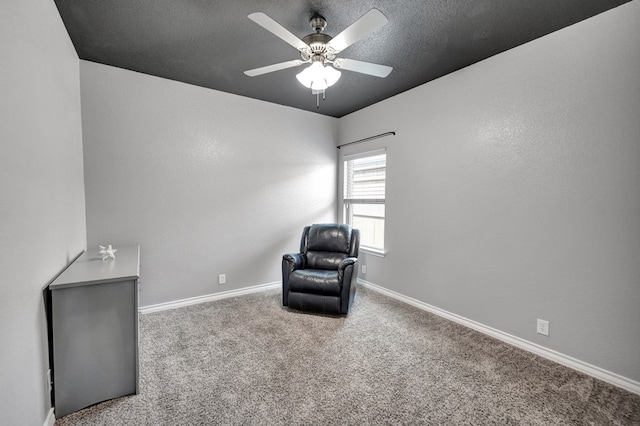 unfurnished room with a textured ceiling, baseboards, a ceiling fan, and carpet floors