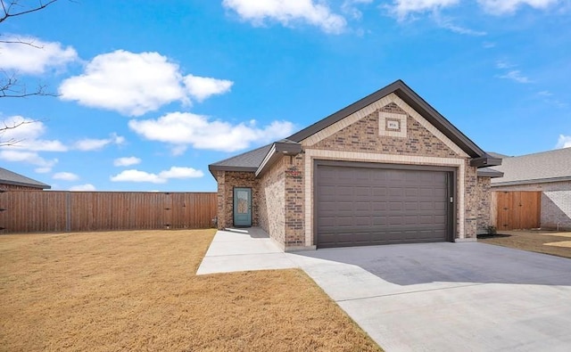 view of front facade with fence, driveway, an attached garage, a front lawn, and brick siding