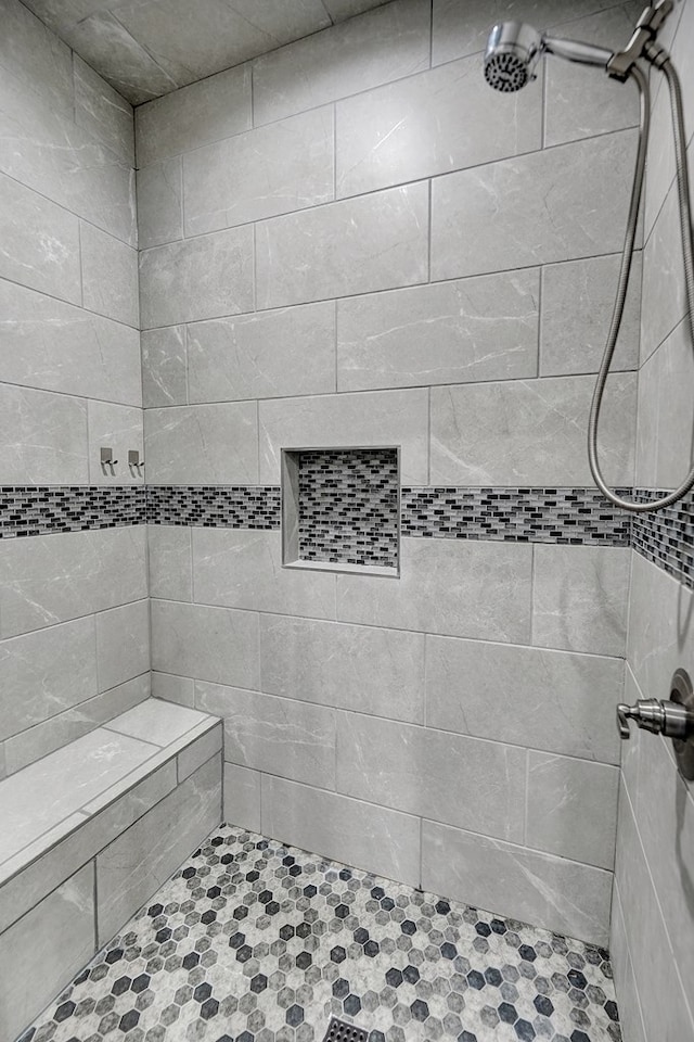 full bath with a tile shower