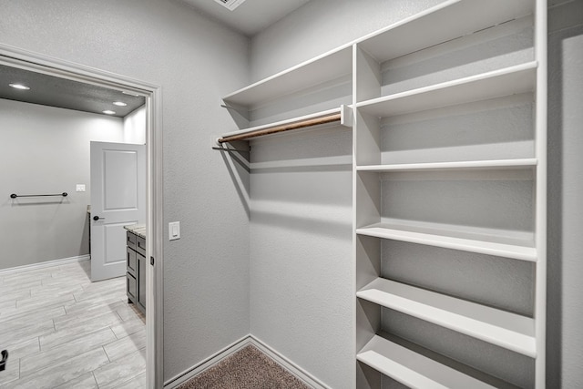 spacious closet with wood finish floors