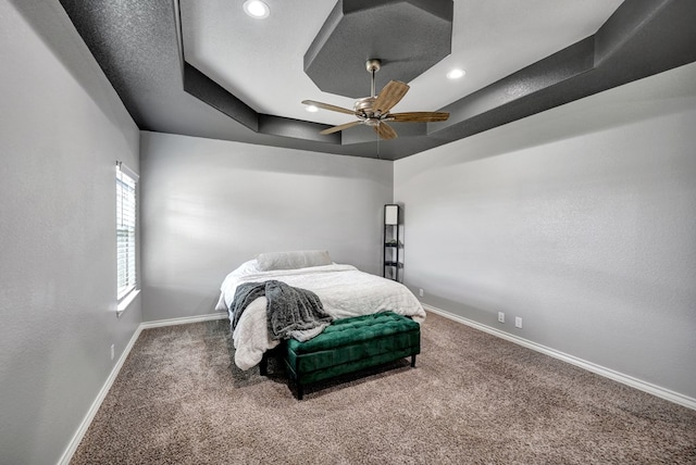 bedroom with a raised ceiling, carpet flooring, recessed lighting, and baseboards