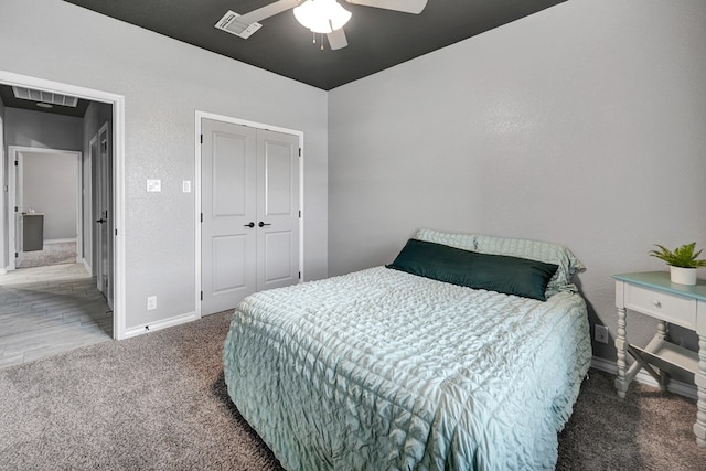 bedroom with visible vents, carpet floors, a closet, and a ceiling fan