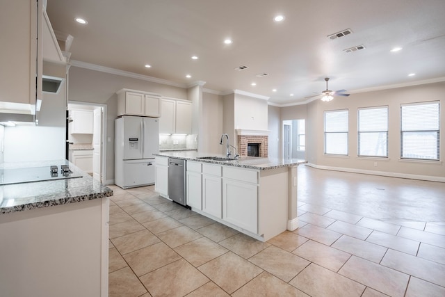 kitchen featuring dishwasher, sink, white cabinets, a kitchen island with sink, and white fridge with ice dispenser