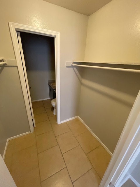 walk in closet with light tile patterned flooring