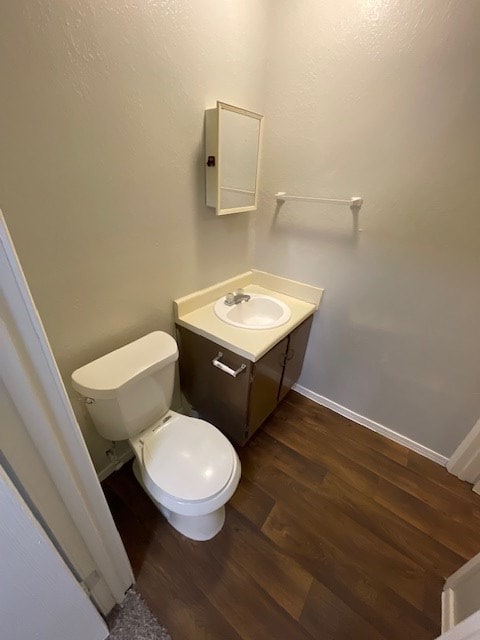 bathroom with vanity, hardwood / wood-style floors, and toilet