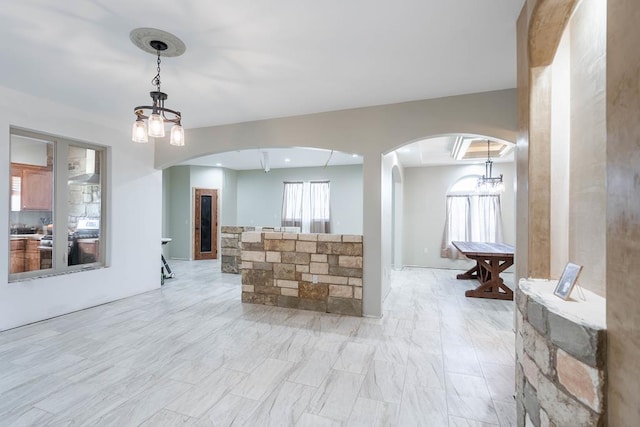 interior space with decorative light fixtures and an inviting chandelier