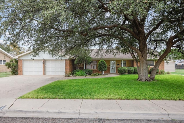 ranch-style home with a garage and a front yard