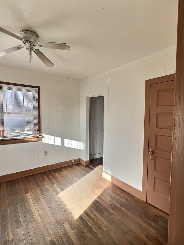 unfurnished room with ceiling fan and hardwood / wood-style flooring