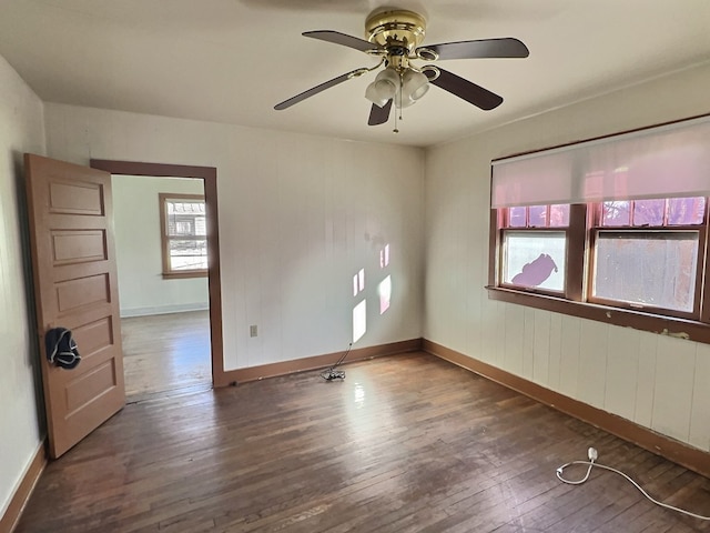 unfurnished room with dark hardwood / wood-style flooring and ceiling fan