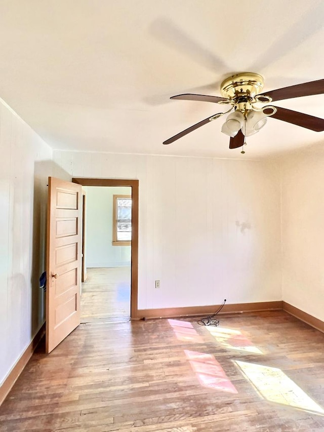 empty room featuring ceiling fan and light hardwood / wood-style flooring