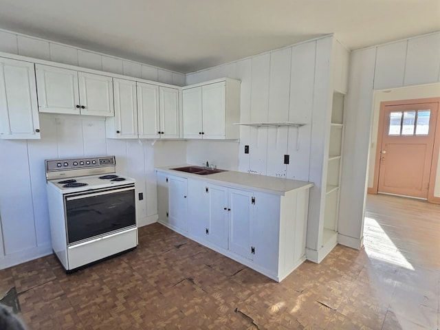 kitchen featuring sink, white electric stove, dark parquet floors, and white cabinetry