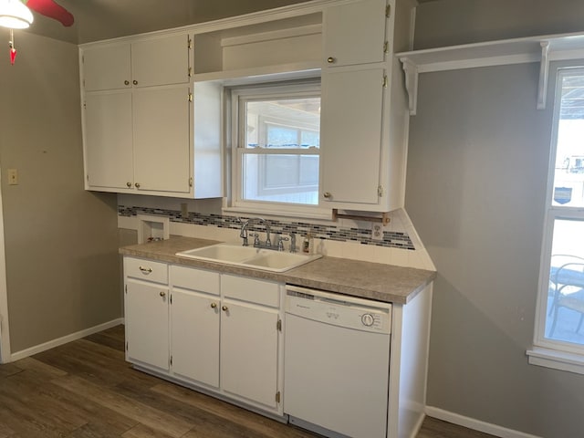 kitchen with white cabinets, sink, and white dishwasher