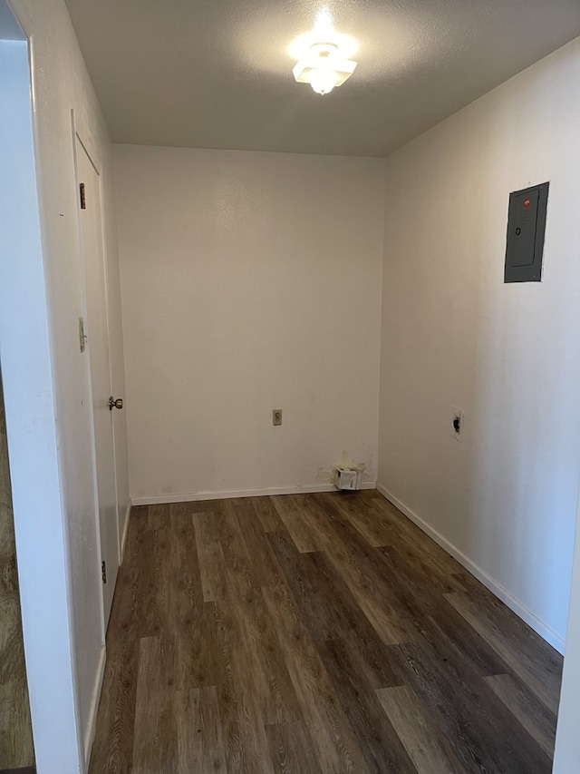 laundry area featuring a textured ceiling, electric panel, dark hardwood / wood-style flooring, and hookup for an electric dryer