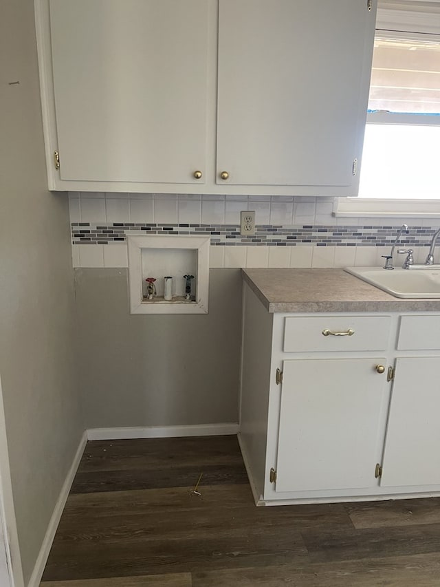 laundry room with cabinets, dark hardwood / wood-style floors, sink, and hookup for a washing machine