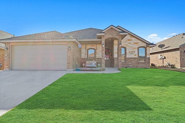 view of front of home with a garage and a front yard